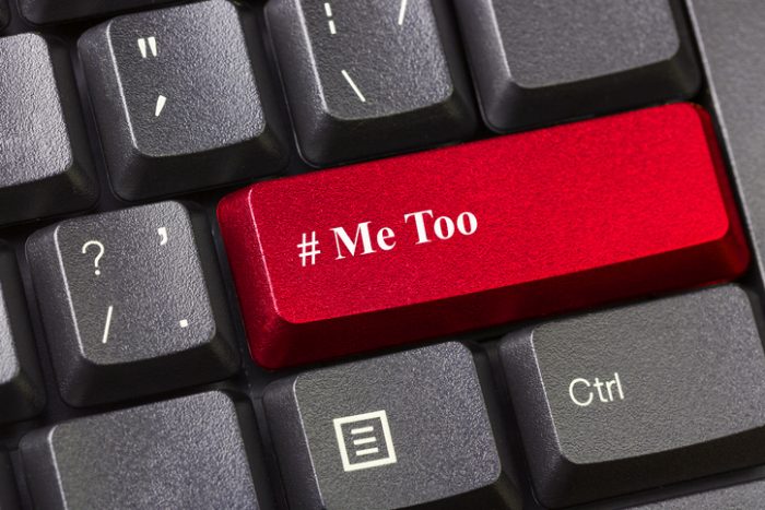 Red colored Me Too button on black computer keyboard. Sexual harassment concept