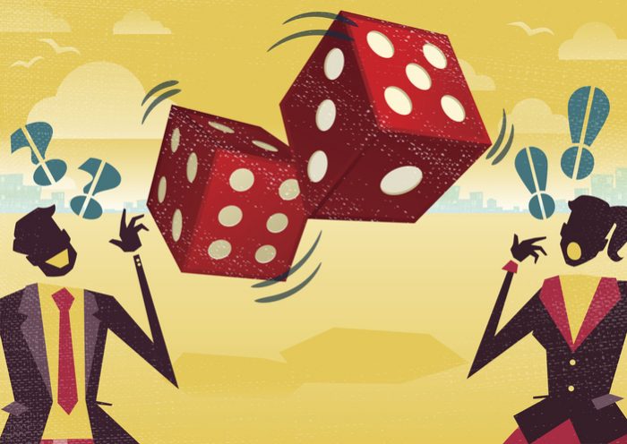 Business people rolling the dice of risk