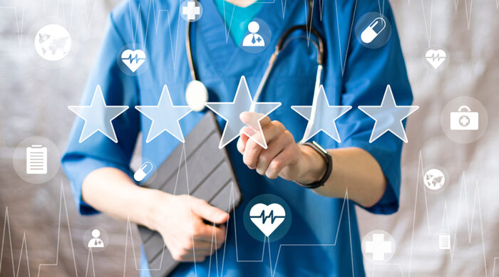 A medical professional wearing blue scrubs receives a star online review.