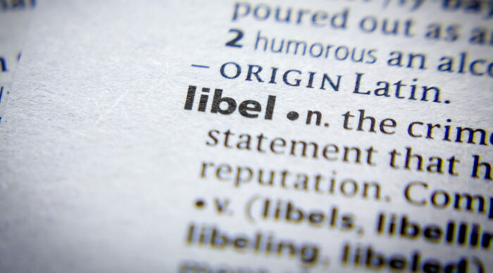 The definition of libel written in black text on white printer paper.