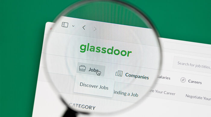 Clear magnifying glass held over the Glassdoor logo and job search feature.