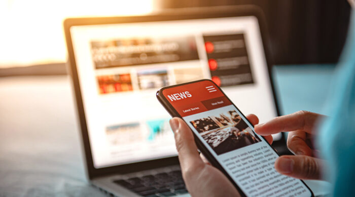 Viewing a news article on a smartphone and laptop, representing challenges of removing personal information online under right to be forgotten in the United States laws.